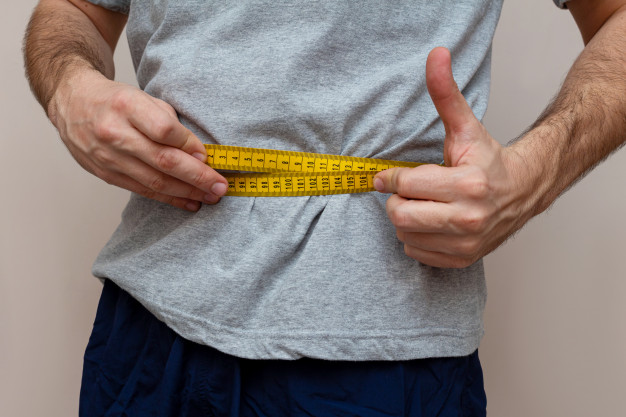 man measuring waist