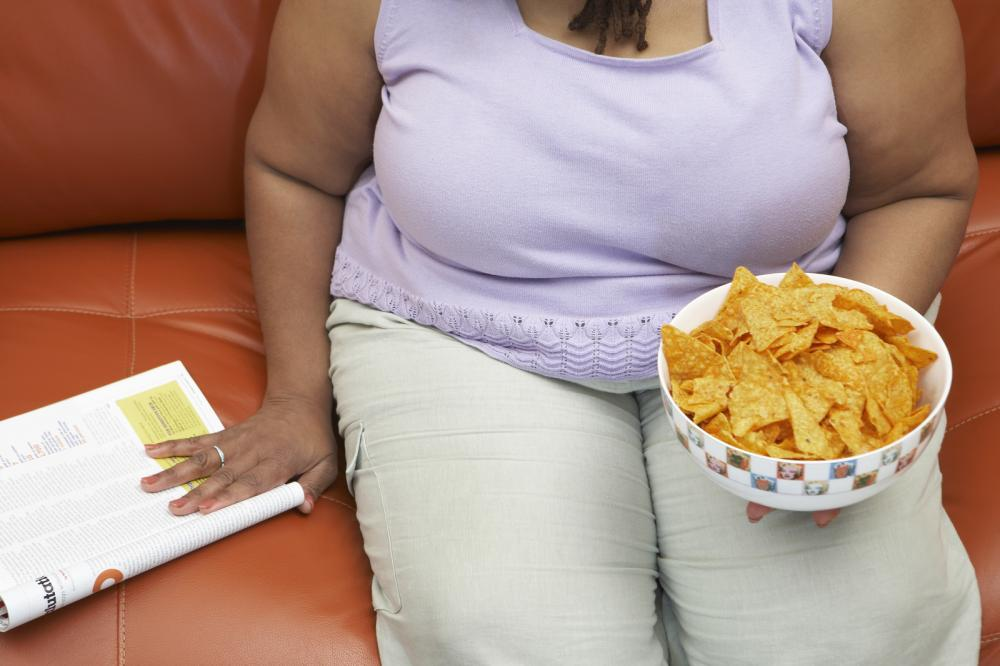 Obese woman sitting on a couch. 