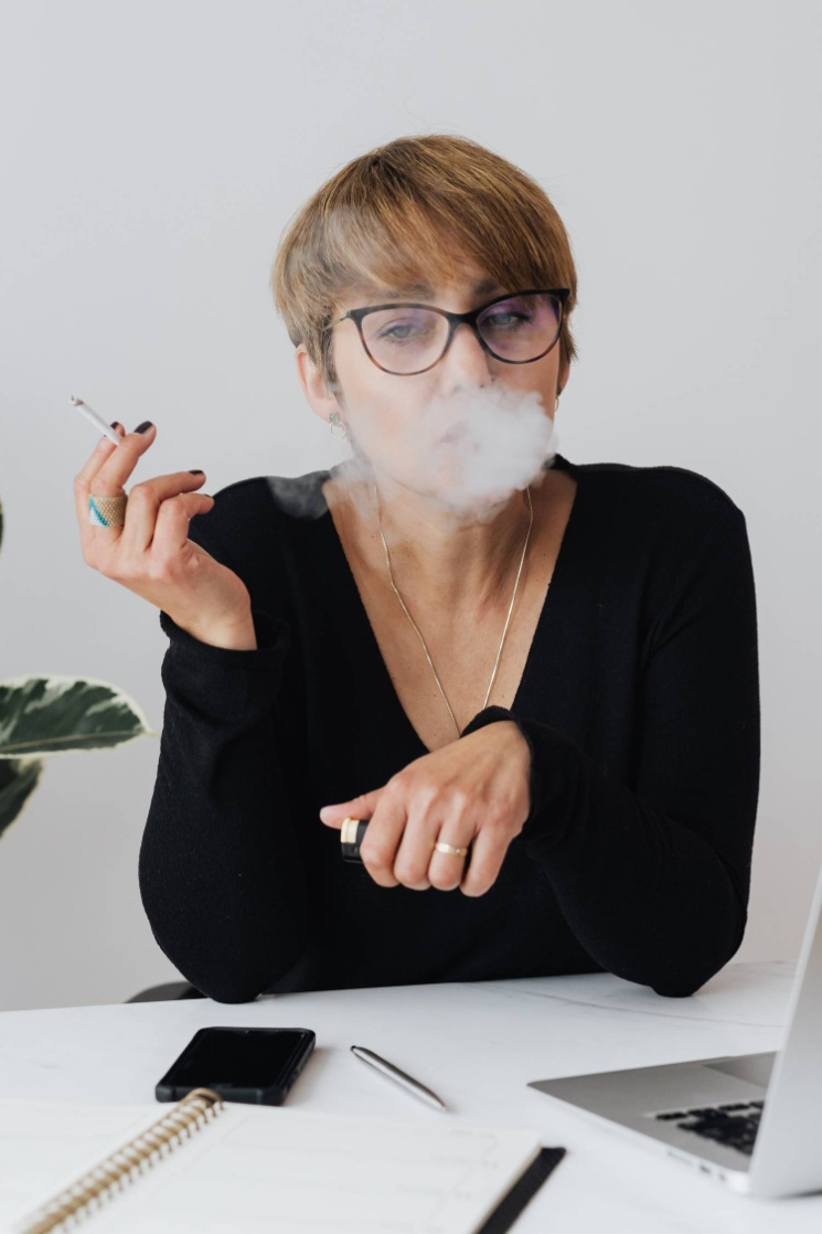 Female employee smoking cigarette