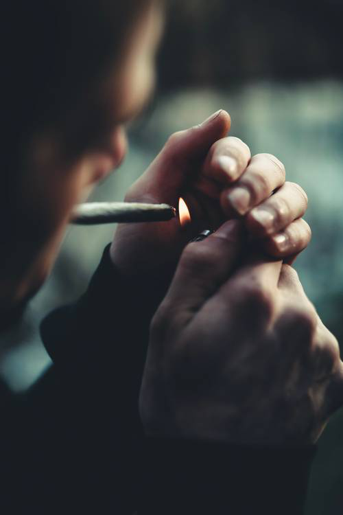 man lighting a cigarette 