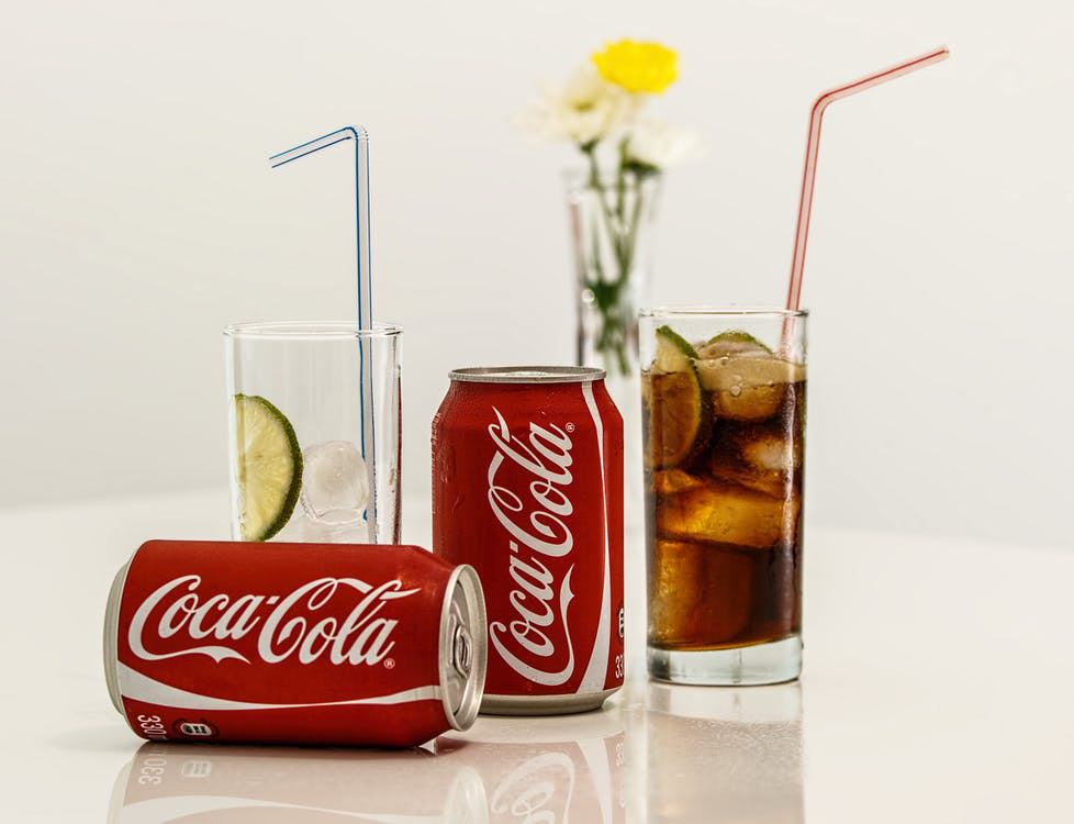 Coca Cola poured out into a glass.